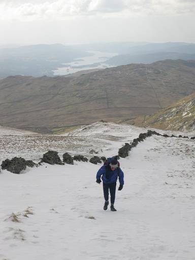 12_45-1.jpg - Paul climbing Pike How, with Windermere in thew background. We should have brought crampons for this bit.