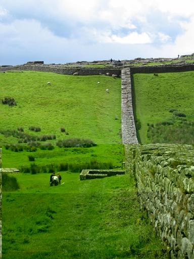 12_23-1.jpg - Approaching Housesteads fort. We paused to take our waterproofs off here. By the time they were off it was raining again. By the time they were back on, it was snowing. We stopped here for some lunch - for once there was no convenient pub.